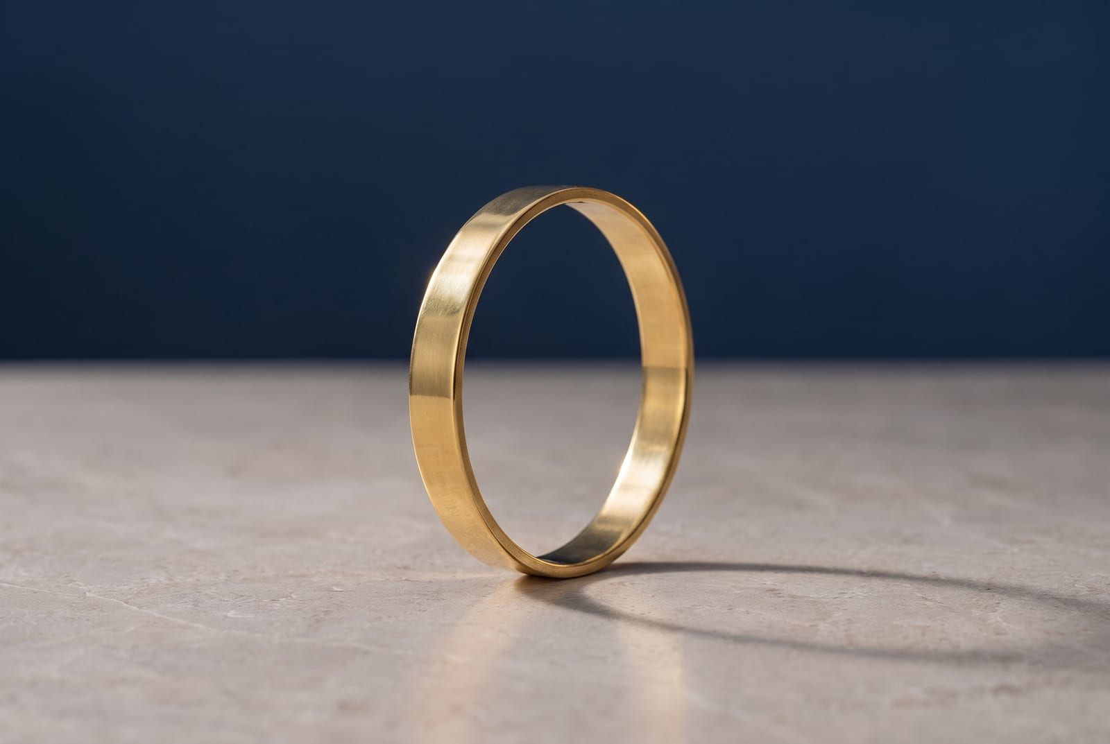 A polished brass ring standing upright as a complete circle.